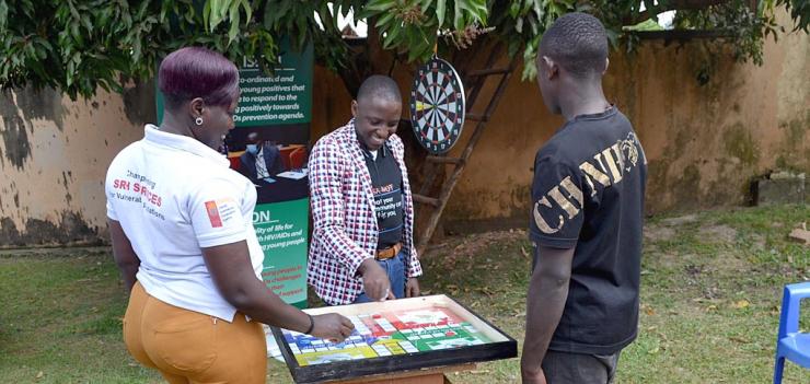 As part of the GUIDE program, Kurdish (center) used board games to gather young boys and men together to involve them in the fight against HIV