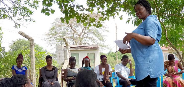 Harriet Adong (standing) leads a mentorship session with the girls participating in her project.