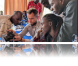 Patricia (right, center) and her group receiving instructions on shooting a documenrary style interview from a Rana Labs trainer. 