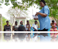 Harriet Adong (standing) leads a mentorship session with the girls participating in her project.