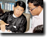 Sotheara Chhim, Executive Director of the Transcultural Psychosocial Organization Cambodia (right), consults with visitors Burma representives from the Assistance Association for Political Prisoners and Social Action for Women on mental health.